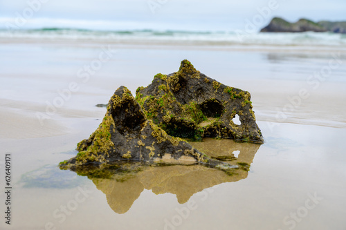 View on Playa de Borizo in Celorio, Green coast of Asturias, North Spain with sandy beaches, cliffs, hidden caves, green fields and mountains. photo