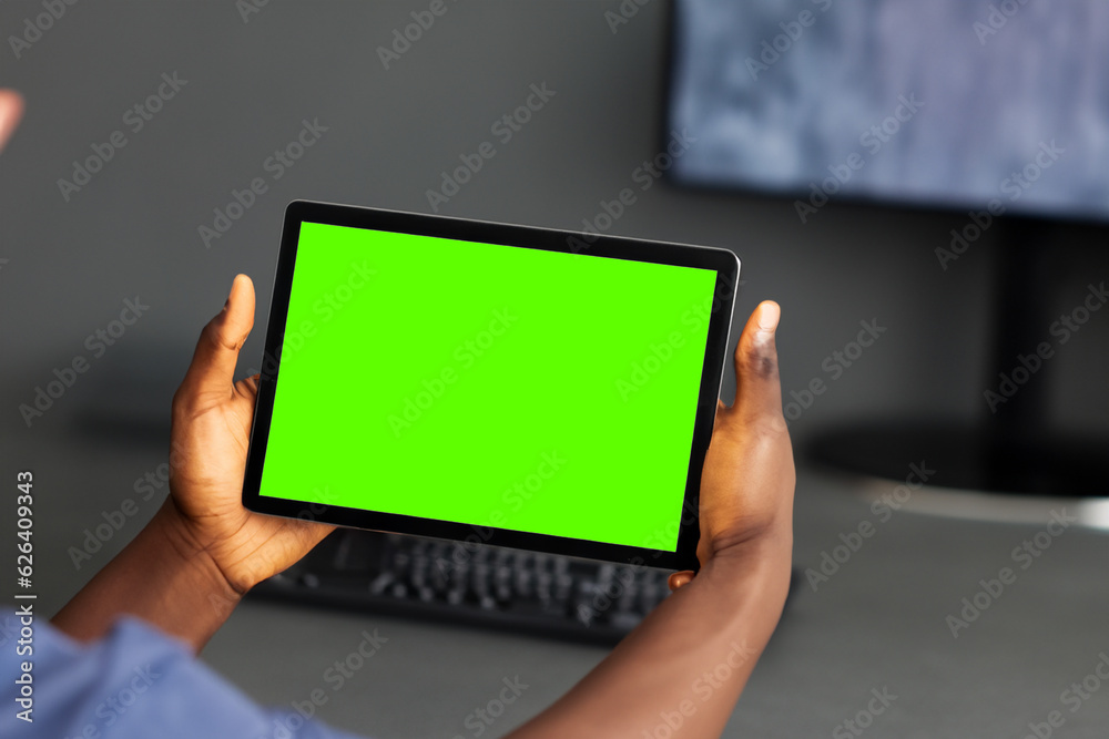 Person of color holding a table with chroma green screen. Easy to edit, technology and networking asset, generative ai Person of color holding a table with chroma green screen. Easy to edit, technology and networking asset, generative ai
