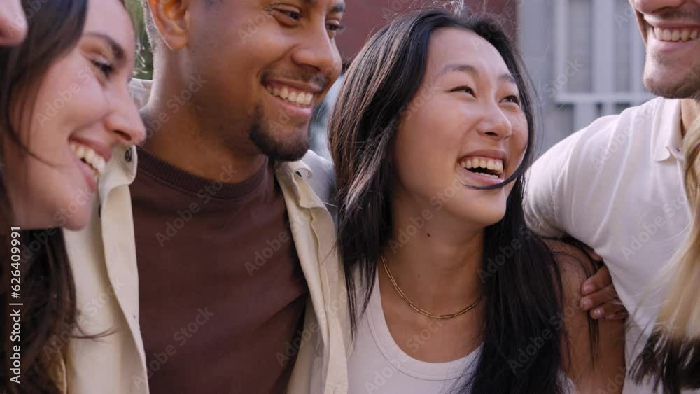 A group of young multiracial people coming together with a common goal, putting their hands on top. Students making a stack in unity standing in circle together in community celebrating success