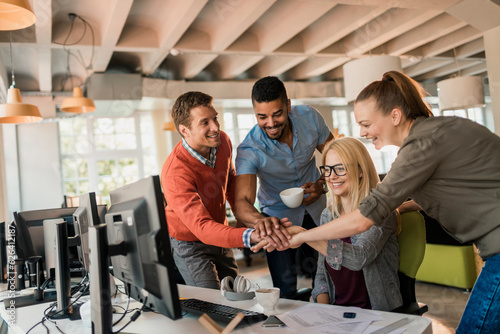 Young group of office worker joining hands in a sign of teamwork