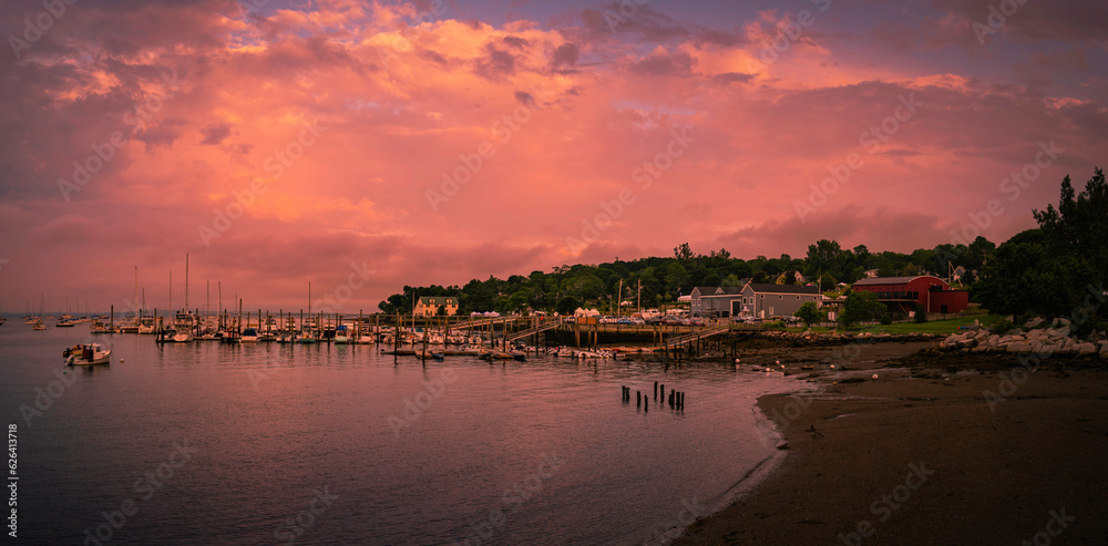 Belfast Harbor at Twilight in Maine. Saturated vibrant and tranquil marina landscape at dawn with moored recreational and commercial boats and ships.