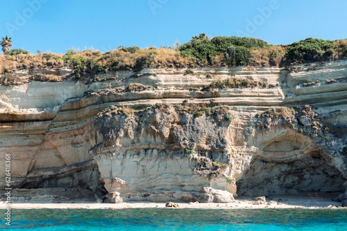 View of coastline in southern Italy. Scenic view from the boat on sunny summer day. Calabria, Scilla rocky shore