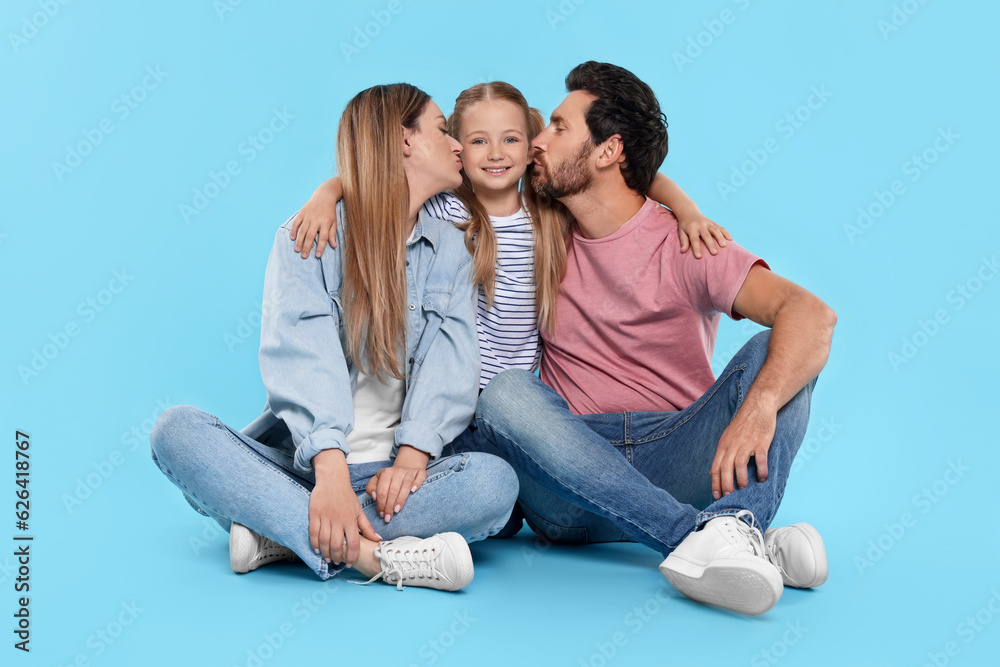 Happy family together on light blue background Happy family together on light blue background