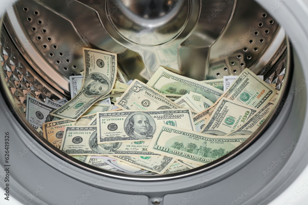 Dollar banknotes in washing machine, closeup
