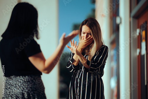Woman Crying Fighting with Her Best Friend Outdoors. Unhappy emotional girl disagreeing with her sister 