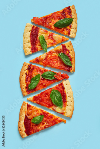 Slices of tasty pizza on blue background