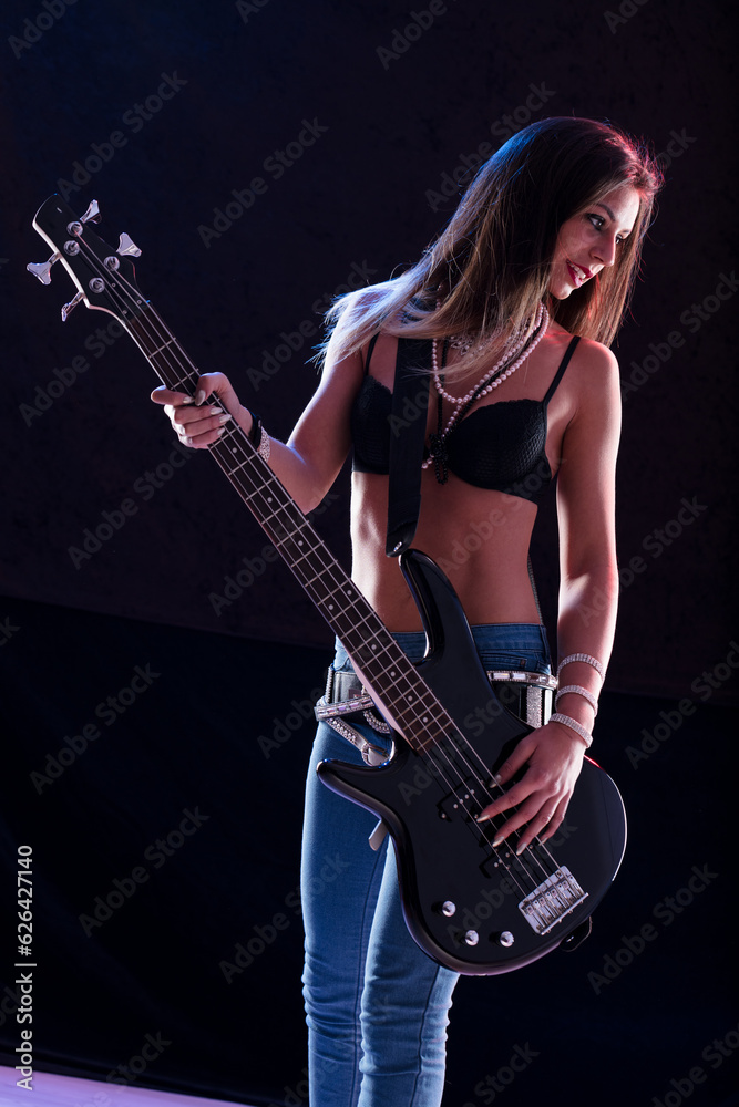 Bass-playing star, sexy attire, confident on stage