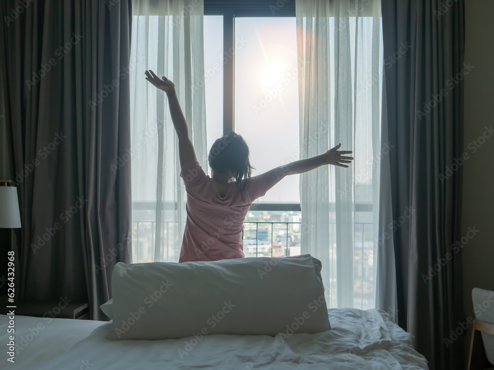 A woman is happy in her bed in the morning. A woman is happy in her bed in the morning.