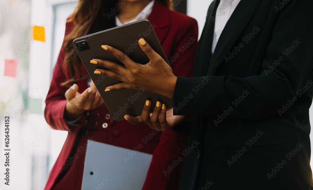 Asian Business woman using calculator and laptop for doing math finance on an office desk, tax, report, accounting, statistics, and analytical research concept