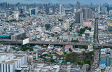 Condominium buildings, houses, expressway roads in the middle of the city. High angle view of the capital city of Bangkok, 