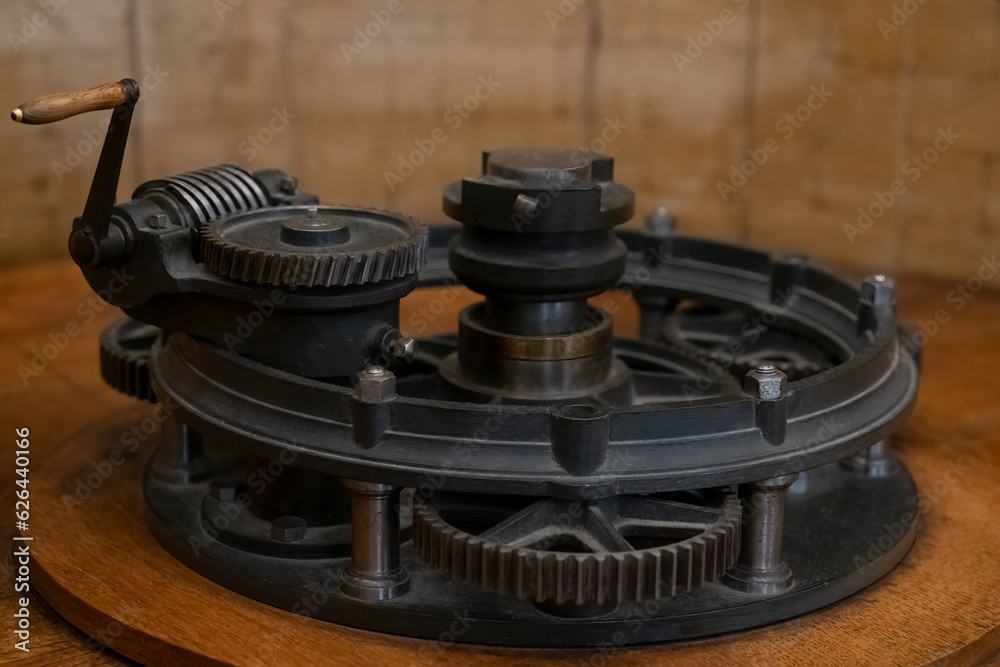 Image of an antique turbine hand crank generator invented in the mid 19th century. Focus on foreground Image of an antique turbine hand crank generator invented in the mid 19th century. Focus on foreground