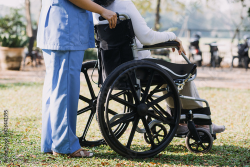 young asian physical therapist working with senior woman on walking with a walker