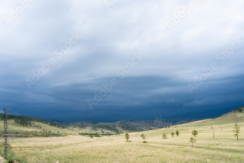 landscape with clouds. A powerful thunderstorm front in the steppe. Rain clouds over the steppe.