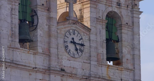 Church bells and clock in Nazare, Portugal town center above famous big wave surf break. photo