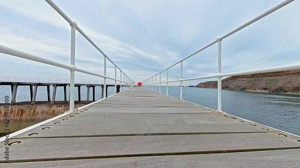 Whitby, North Yorkshire, UK – June 30 2023. Push in shot of wooden bridge in Whitby harbour on the North Yorkshire coast Whitby, North Yorkshire, UK – June 30 2023. Push in shot of wooden bridge in Whitby harbour on the North Yorkshire coast