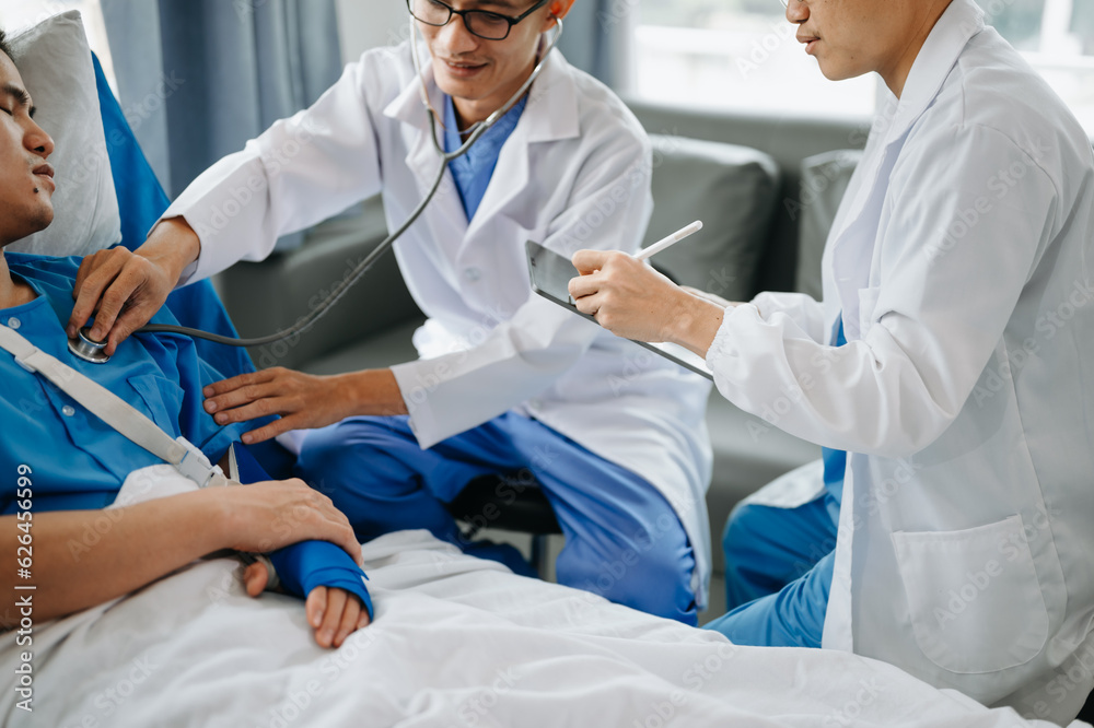 Hospital Ward Male and Femle Professional Asian Doctors Talk with a Patient, Give Health Care Advice, Recommend Treatment Plan with Advanced Equipment . Hospital Ward Male and Femle Professional Asian Doctors Talk with a Patient, Give Health Care Advice, Recommend Treatment Plan with Advanced Equipment .