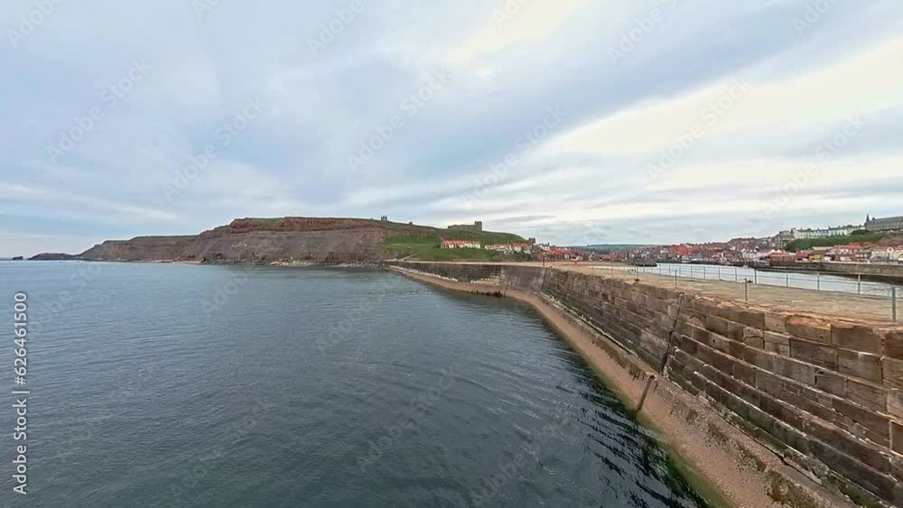 Whitby, North Yorkshire, UK – June 30 2023. The outer harbour wall and North Sea in Whitby on the North Yorkshire coast Whitby, North Yorkshire, UK – June 30 2023. The outer harbour wall and North Sea in Whitby on the North Yorkshire coast