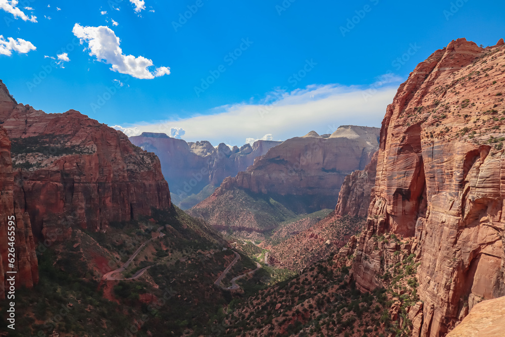 Panoramic aerial view from Zion National Park Canyon Overlook, Utah, USA. Tranquil atmosphere in wilderness. Uninhabited canyon with majestic rock formations and steep cliffs. Mountains, serene sky