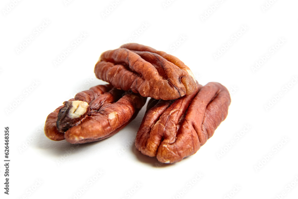 Pecan nut kernels isolated on a white background. Heap of peeled pecan halves
