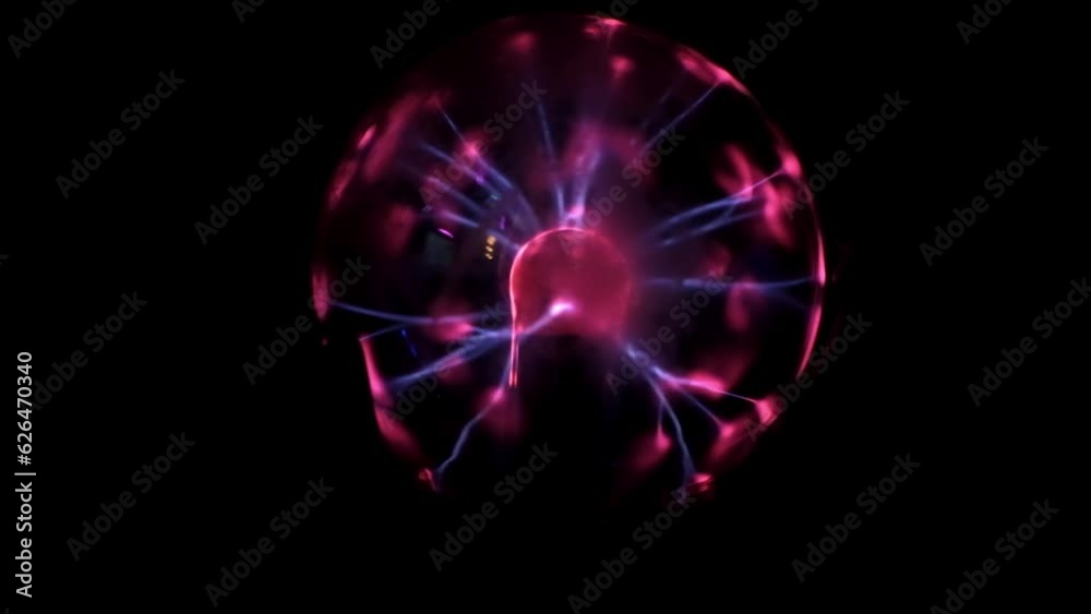 Tesla coil. Plasma globe. Blue and purple light beams. Energy rays moving from side to side. Coil electric discharge. Close-up. Magic object. Plasma Sphere Static Electricity. Decoration. Tesla coil. Plasma globe. Blue and purple light beams. Energy rays moving from side to side. Coil electric discharge. Close-up. Magic object. Plasma Sphere Static Electricity. Decoration.
