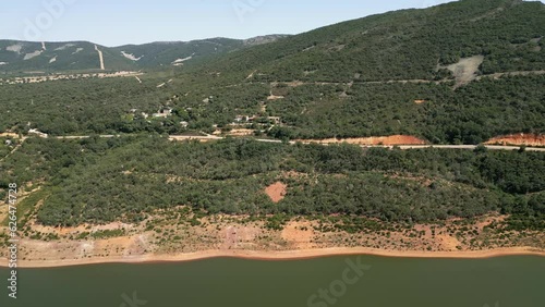 Car driving on a mountain road next to a lake in central Spain. photo