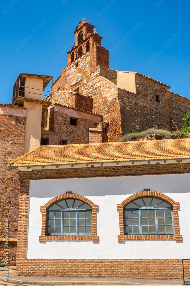 Church tower and old buildings in the closed mine of Almacen, Ciudad Real, Spain.