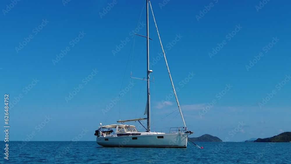 Sailing yacht in the sea against the sky, the sailing yacht stands on the mooring Sailing yacht in the sea against the sky, the sailing yacht stands on the mooring