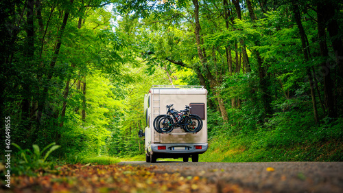 Motor home in the forest- travel, adventure, road trip concept