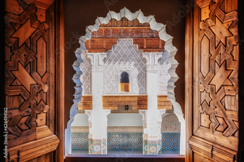 Detail of a window of the madrase of Ben Youssef, in Marrakech. La Madrasa is an old school and one of the city's tourist points. photo