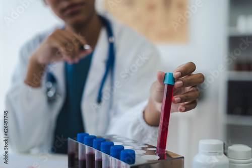 Doctor analysis the blood test examination results and medication usage of the patient on the chart, medical check-up concept.