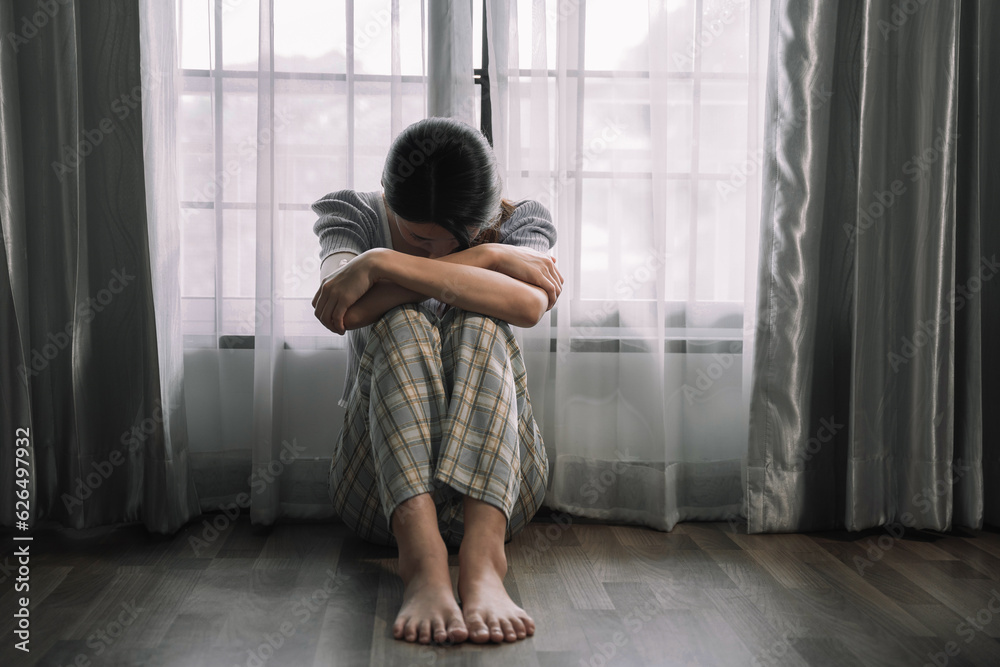 Sad and depressed young female sitting on the floor in the room, sad mood,feel tired, lonely and unhappy concept. Sad and depressed young female sitting on the floor in the room, sad mood,feel tired, lonely and unhappy concept.