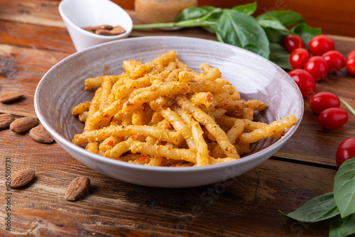 Sicilian pasta with almond and tomatoes pesto. Typical Italian food from Sicily, pasta with red pesto.