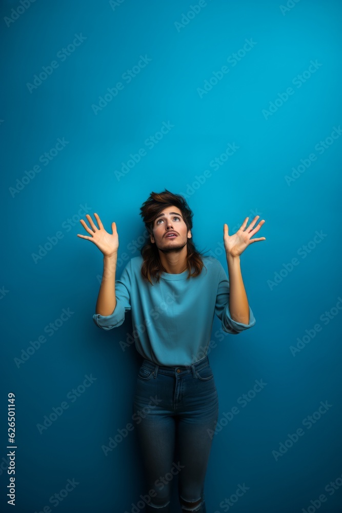 Scared man with raised hands, blue background Scared man with raised hands, blue background