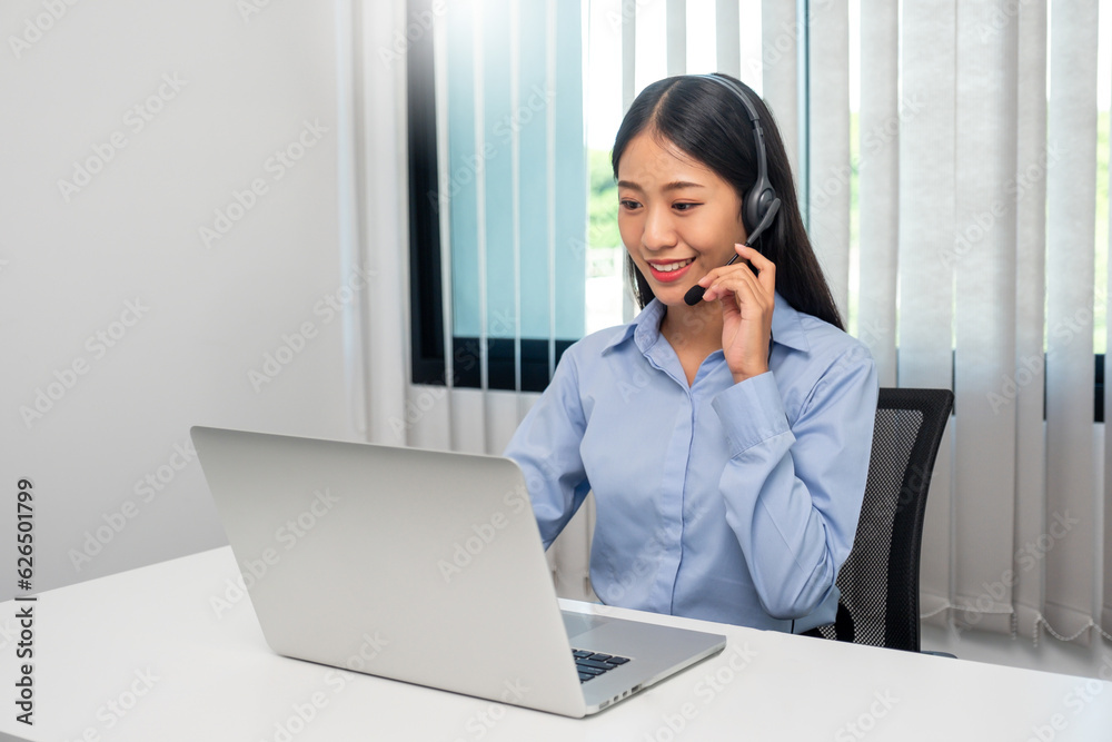 Female call center operator with headset working on support hotline in modern office Teleconferencing via video. online training. Female call center operator with headset working on support hotline in modern office Teleconferencing via video. online training.