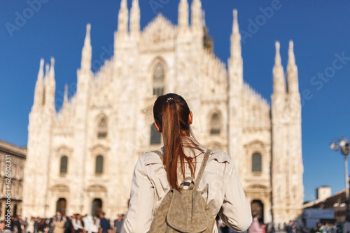 Tourist woman near Duomo di Milano cathedral church. Milan, Italy