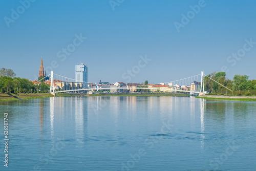Pedestrian bridge over the Drava river and skyline of city of Osijek, Croatia