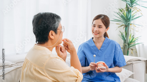 Female Dentist Providing Dental Treatment for Senior Woman at Home. Healthcare and Home Care Concept. Female professional doctor.