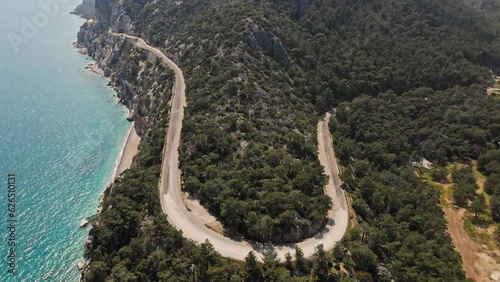 aerial drone footage of beautiful scenic landscape of Marmaris peninsula, mountains and hills with green woods and curved road to Datca destination. peninsula surrounded Aegian and Mediterranean seas. photo