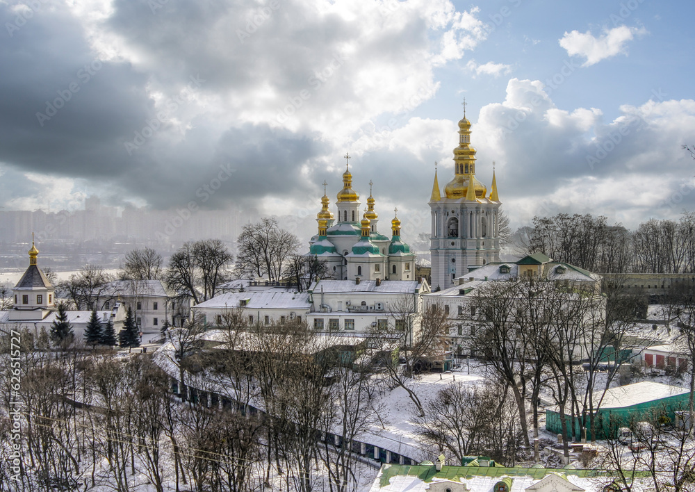 A view on Kiev Monastery of the Caves in winter with snow and the city in the background