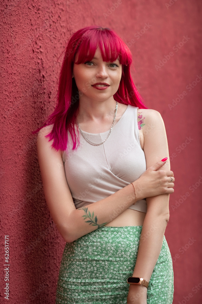 Portrait of a beautiful young girl with red hair, in an urban environment. Portrait of a beautiful young girl with red hair, in an urban environment.