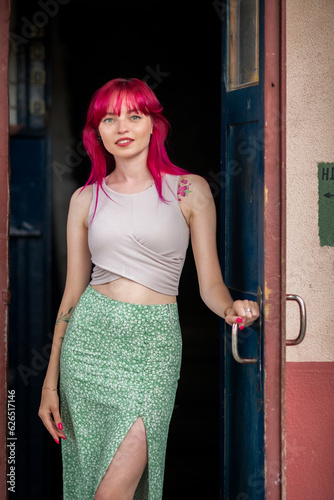 Portrait of a beautiful young girl with red hair, in an urban environment.