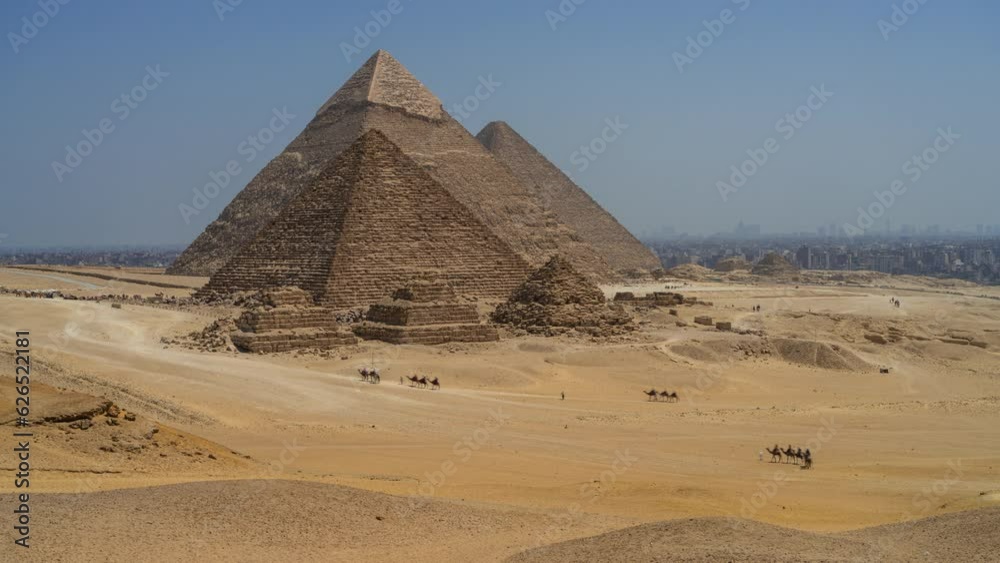 Camels and tourists around the 3 famous pyramids in Giza, Egypt. Timelapse clip. Camels and tourists around the 3 famous pyramids in Giza, Egypt. Timelapse clip.