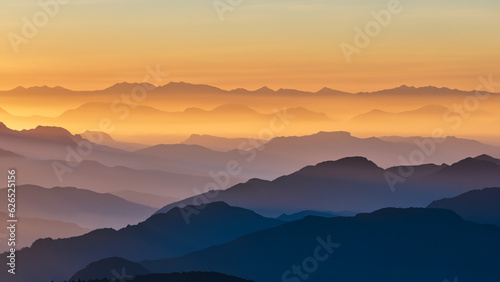 Mesmerizing sunrise over majestic mountains, misty valleys & soaring eagles. Nature's grandeur is captured.