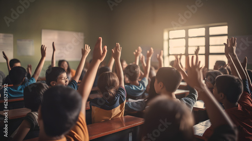 Back to school. Students raising hands in the classroom