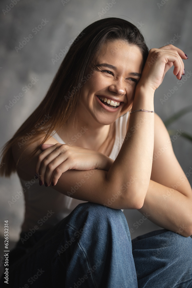 Portrait of an attractive girl with a charming smile. Oriental girl. Large female portrait. Lifestyle Portrait of an attractive girl with a charming smile. Oriental girl. Large female portrait. Lifestyle