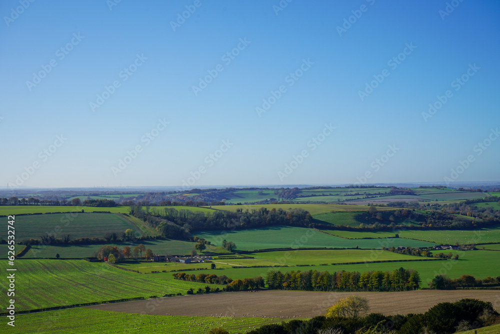 View over green countryside and blue skys