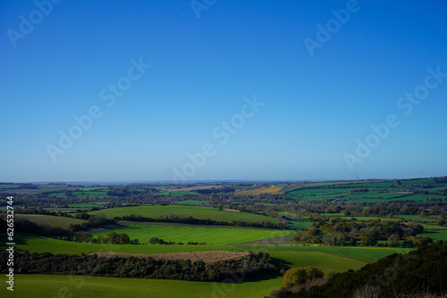 View over green countryside and blue skys
