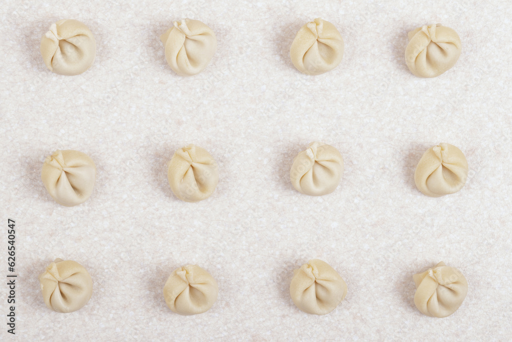 Uncooked dumplings on white table closeup. Homemade dumplings. Top view.