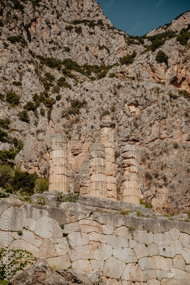 The Temple of Apollo in Delphi, Greece, against the mountain view