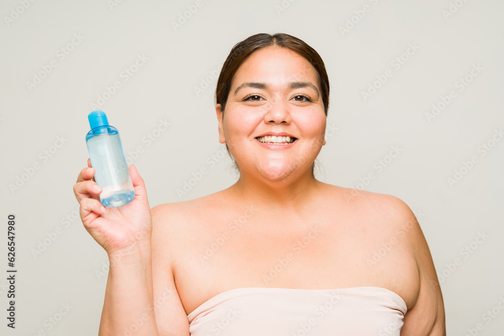 Cheerful large woman showing her makeup remover Cheerful large woman showing her makeup remover
